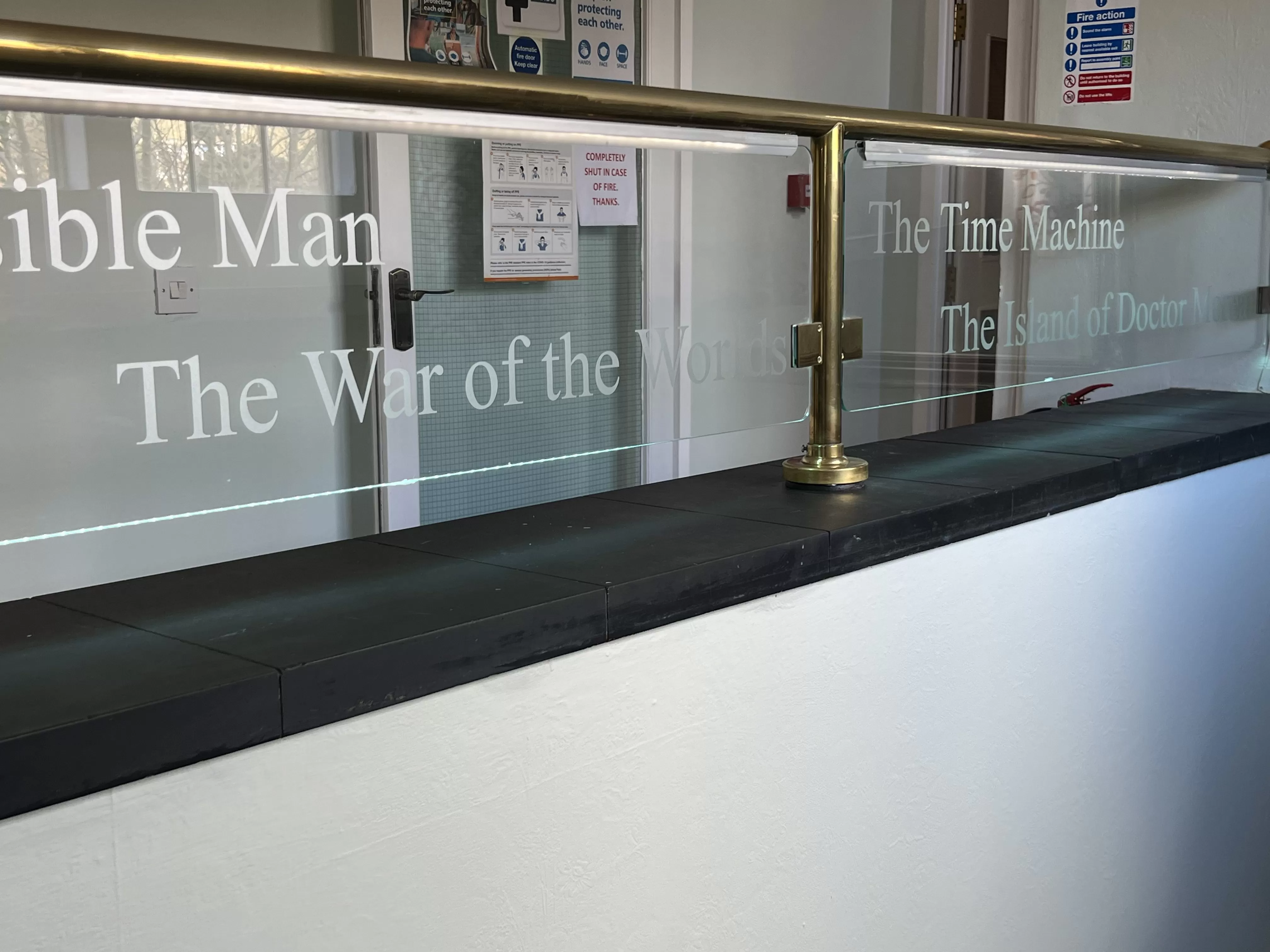 A railing featuring a sign that reads "The War of the World."